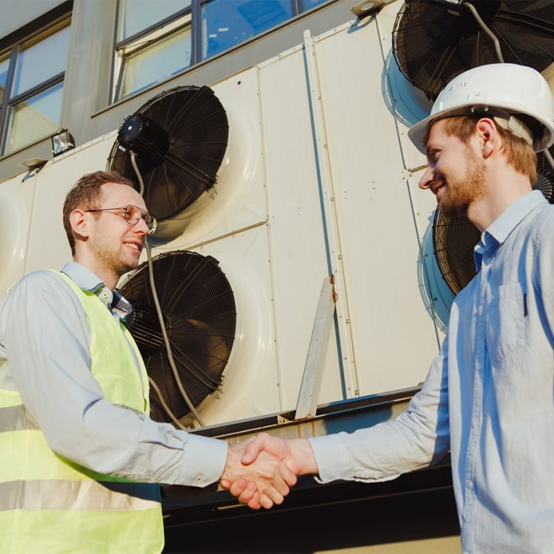 Commercial HVAC professionals discussing a completed HVAC project in Williamsport, PA.